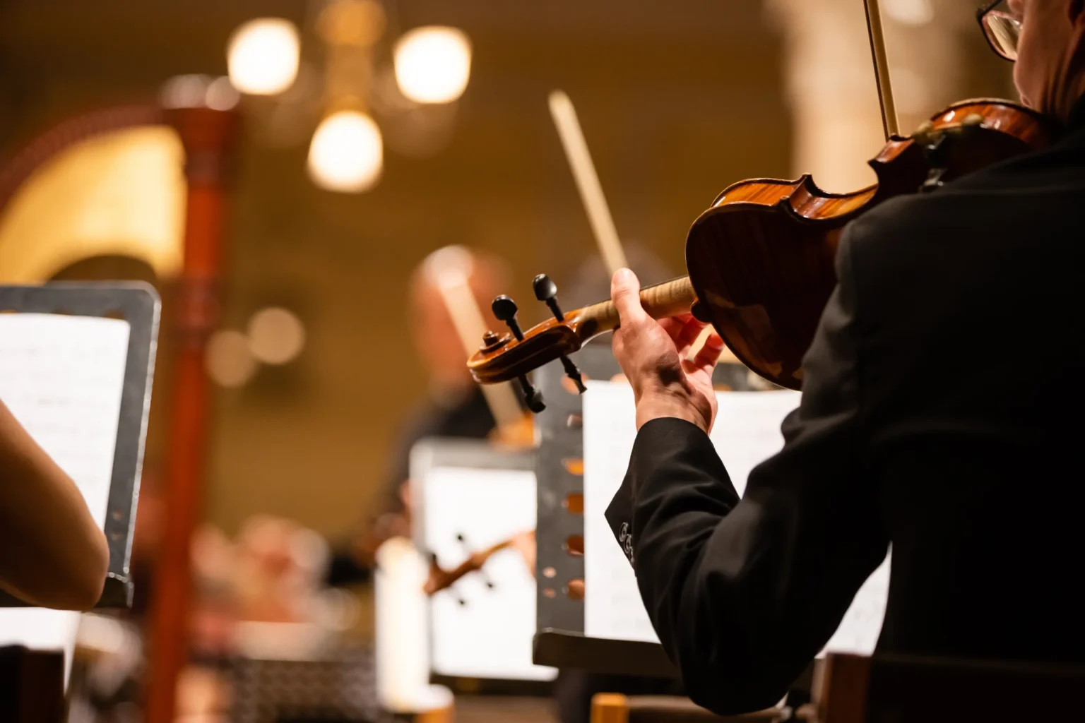 Violinists performing on stage at a New York Music Center concert